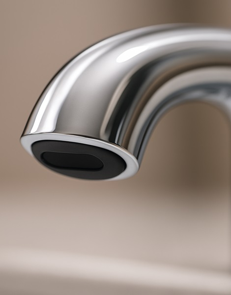 Close-up of infrared sensor window on a corporate touchless faucet