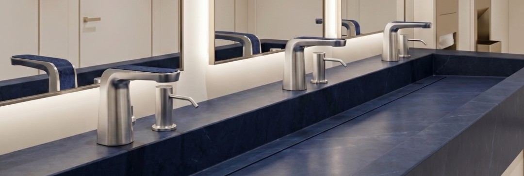 Fontana Elentrax brushed nickel commercial touchless faucet installed on a navy stone washstation