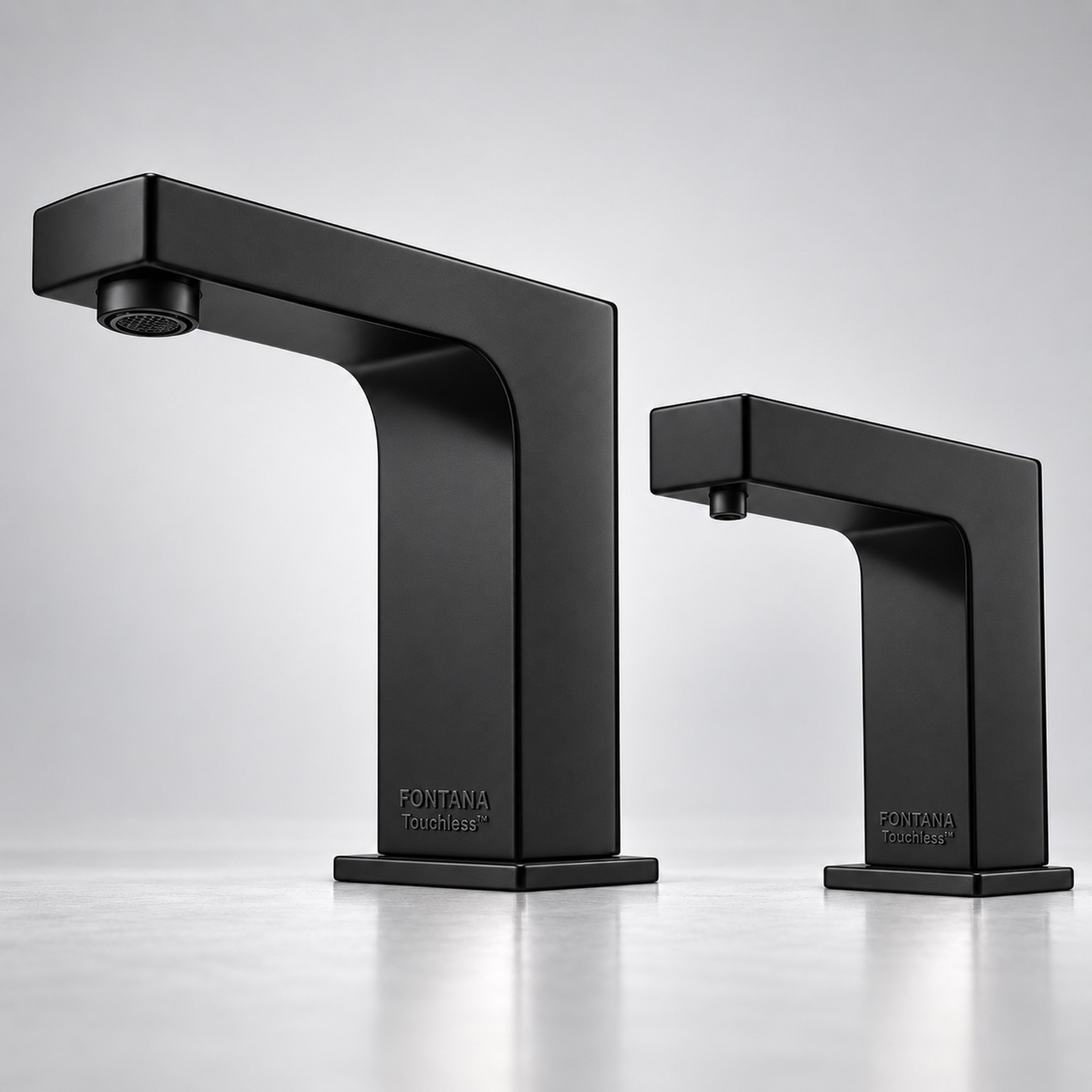 Black commercial touchless faucet showing angular fixture design