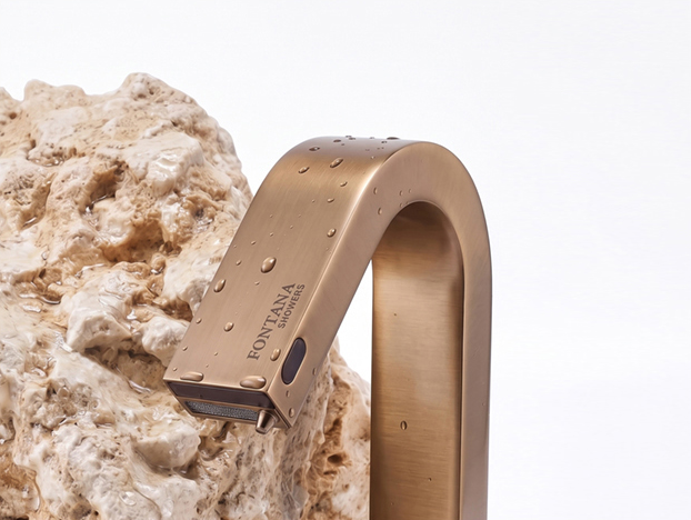 Bronze sensor faucet with water droplets and natural stone