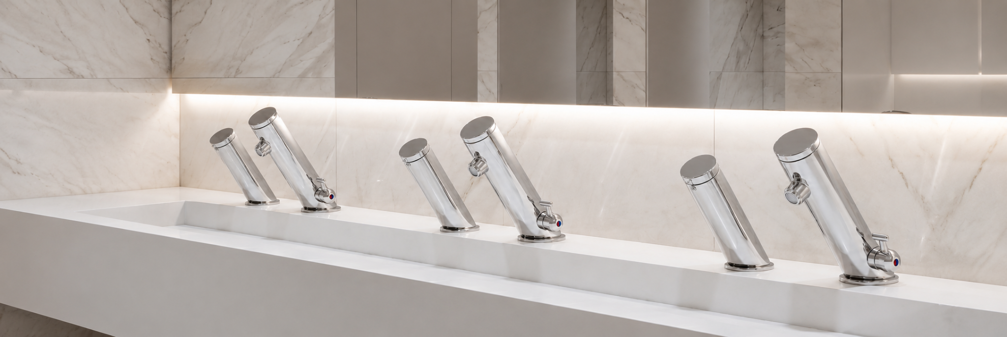 Chrome touchless faucet installation in a luxury commercial restroom