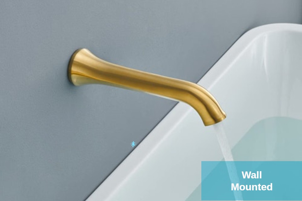 Wall-mounted gold faucet over a basin in a touchless commercial restroom concept
